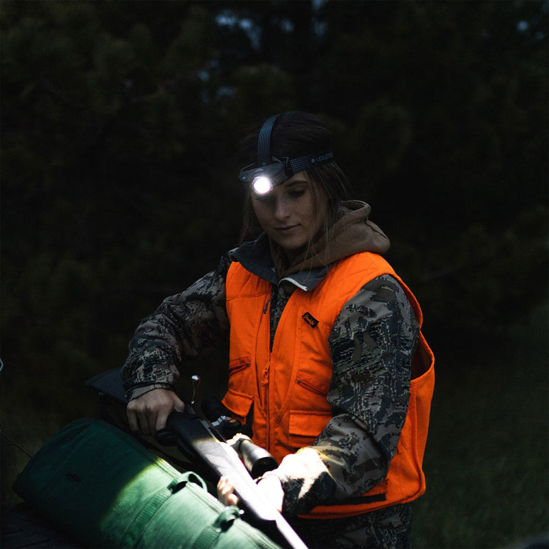 Hunter in blaze orange wearing the MH11 headlamp